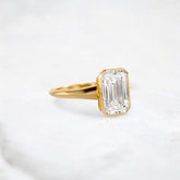 hidden-muse-emerald-glow-bezel-moissanite-engagement-ring-3-ct-yellow-gold-gemfora-2